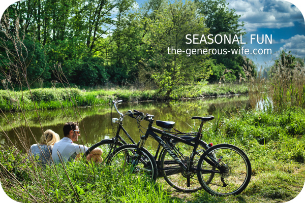couple sitting by creek with bicycles